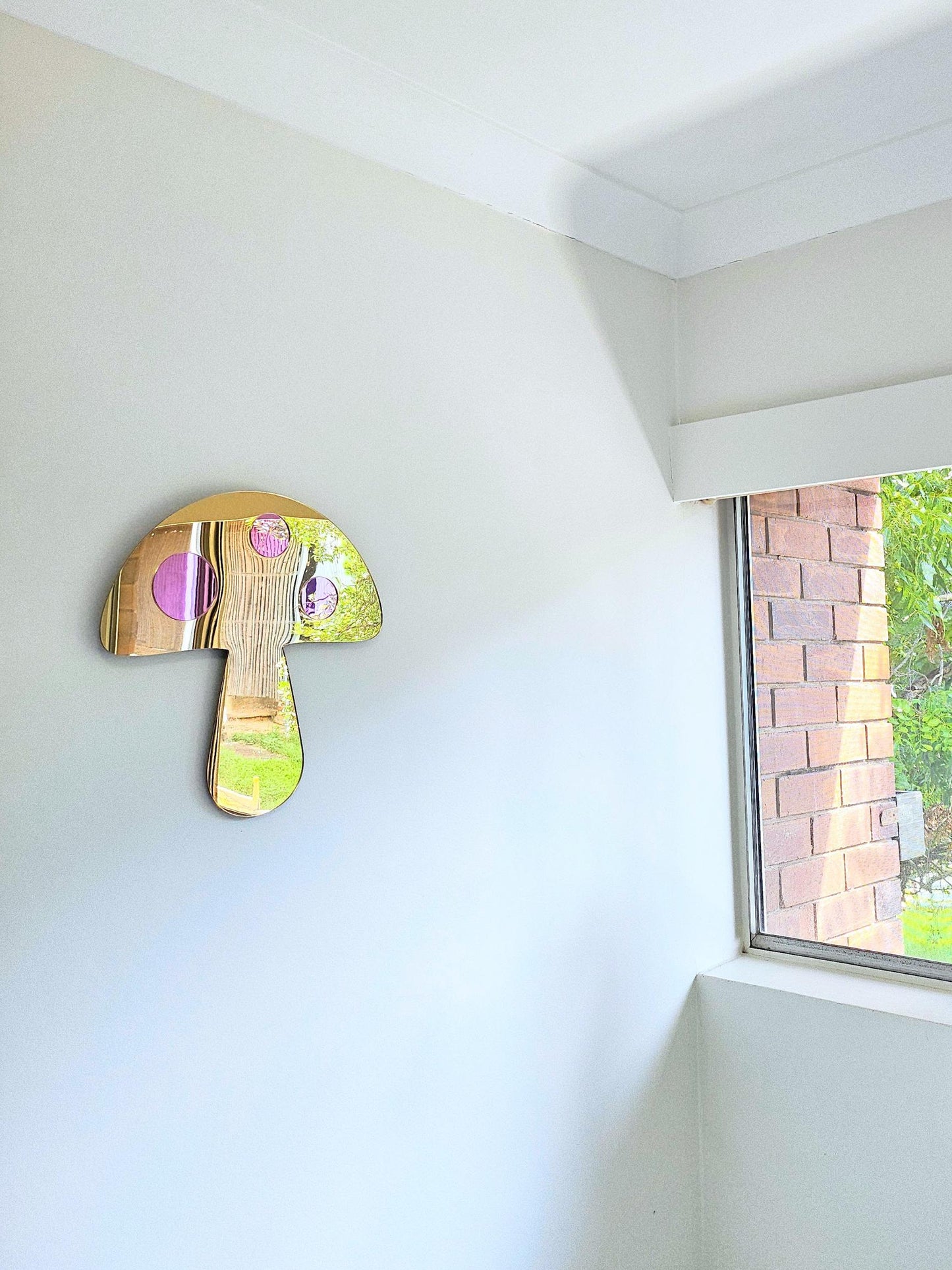 a decorative mushroom-shaped mirror on the wall